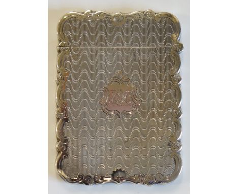 A Victorian rectangular card case, the body engine turned with a geometric pattern, the central shaped cartouche engraved wit