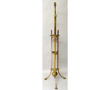 A telescopic brass standard lamp, the central column within two pierced circular frames and incurved triangular base with thr
