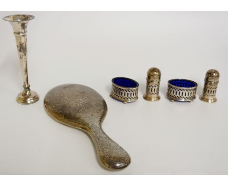 A Georgian style four piece cruet set, the oval salts with blue glass liners on ball feet, the pepper pots with open fret wor