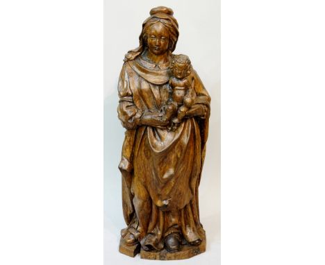 An early 17th Century trunk carving of the Virgin Mary and Child, 100cm high, Circa 1620