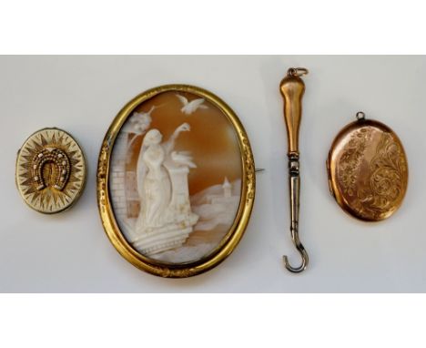 A shell cameo brooch depicting lady with arm raised for bird to perch upon, gold coloured metal border with engraved foliate 