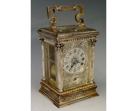 A French silver plated carriage clock, the four glass case decorated overall with trailing foliage and flower heads, the face