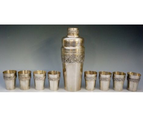 A Chinese silver coloured metal cocktail shaker of tapering rounded octagonal form, with eight matching beakers, the lid and 