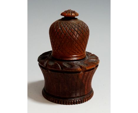 A mid-19th Century engine turned wooden nutmeg grater, the waisted base with turned borders, the slightly domed cover with co