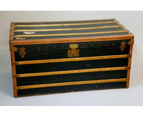 Malles Goyard - a wooden, brass and leather bound trunk, black fabric body, the hinged lid revealing quilted interior and pai