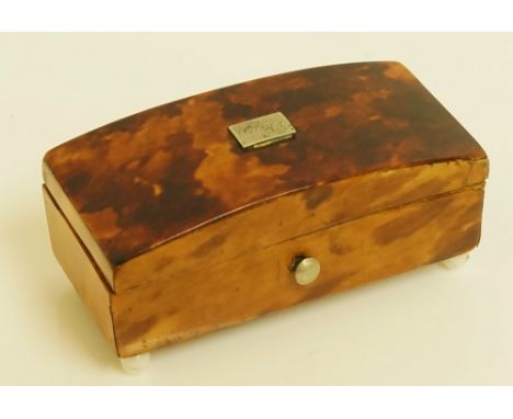 A miniature tortoiseshell veneered box, the domed hinged cover with rectangular white metal tablet, white bead feet, push but