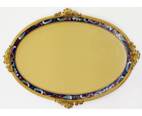 A gilt metal and champlevé enamel oval photograph frame the reeded border with pierced foliate clasps, the inner frame champl