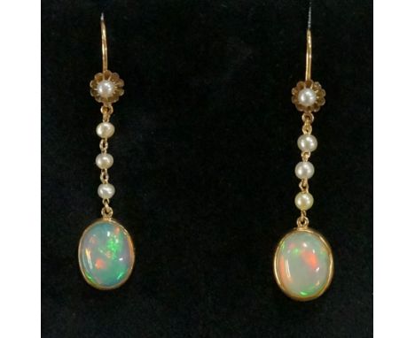 A pair of opal and seed pearl pendant earrings, the upper flower heads set split seed pearl above three further and oval opal