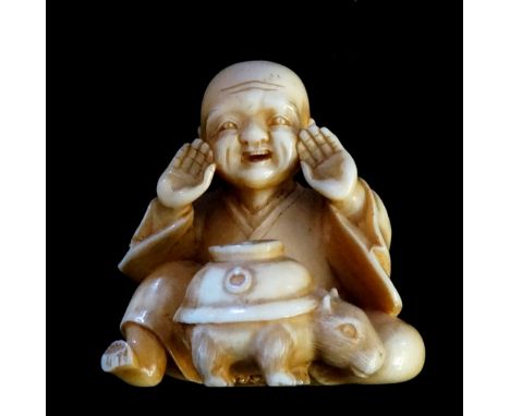 A 19th Century Japanese ivory netsuke finely carved as a seated man with animal at his knee with lidded vessel on its back, 3