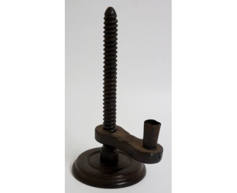 An 18th Century ebonised fruitwood rise and fall candlestick with threaded column, black Japanned candle holder, turned circu