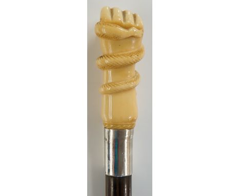 An ivory topped walking stick finely carved with a hand and snake, plain silver collar, tapered shaft with horn ferule, 88cm 