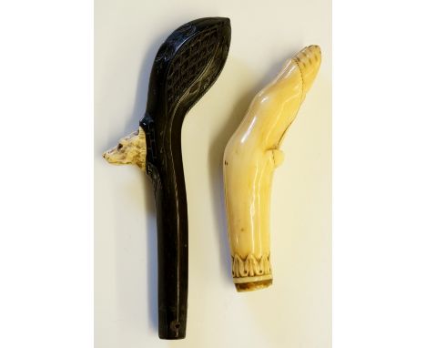 An ivory walking stick handle carved as a hoof, leafage design to end, 13cm high; a bog oak walking stick handle with ivory i