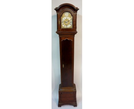 An Edwardian Granddaughter clock the mahogany case with domed hood enclosing an arched brass face the top with circular table