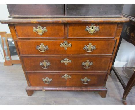 An 18th Century walnut diminutive chest of two short over three long drawers, brass handles and fretwork escutcheons, bracket