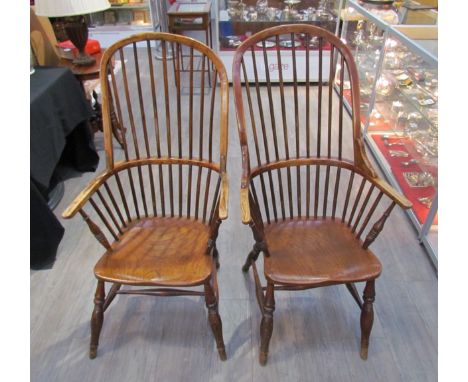 A pair of circa 1800 his and hers Windsor chairs, the hoop and stick-back over a solid elm seat, on turned supports joined by