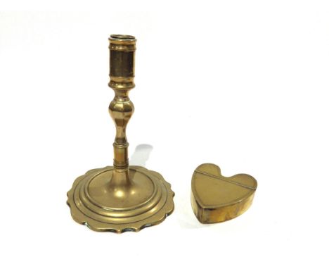 A Georgian brass candlestick and Georgian brass heart form snuff box, 16.5cm tall and 8.3cm long (2) 