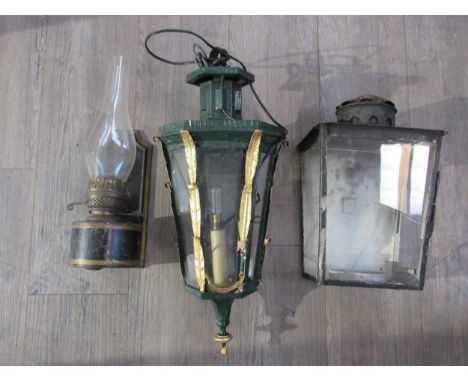 A 19th Century cast iron wall lantern with gilt embellishment, tin wall hanging oil lamp and further wall hanging lantern, 57