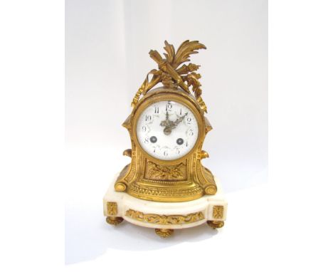 An early 19th Century French Ormolu mantel clock with white enamel dial, Arabic numerals with two trains, movement of classic