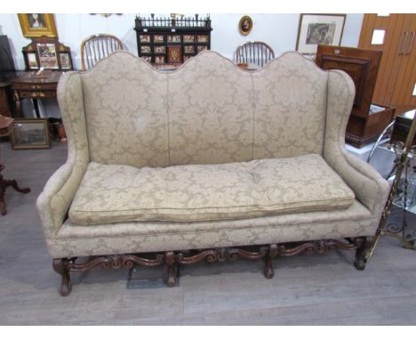 A Georgian style triple hump back sofa, oak frame, foliate design upholstery 