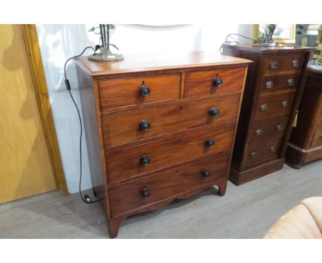 A Victorian flame mahogany chest of two short over three graduating long drawers with turned handles on bracket feet with sha