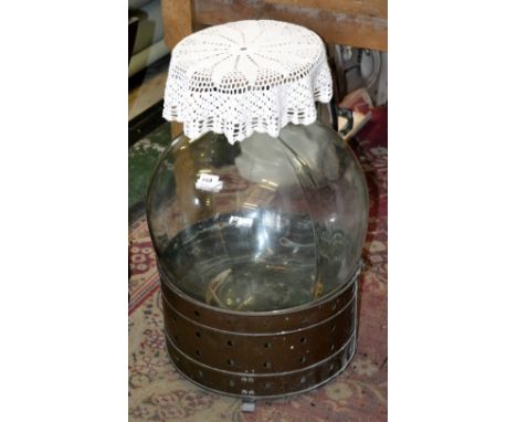 A carboy and copper mounted lamp table