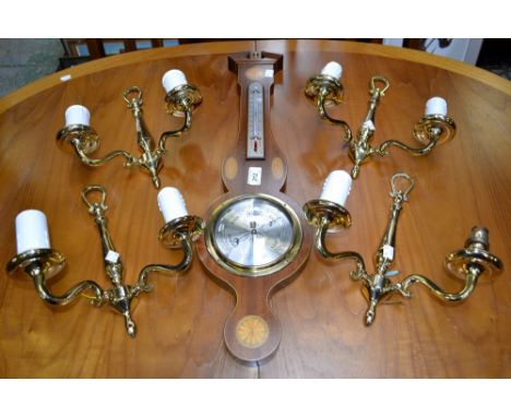A set of four two branch brass wall scones; a mahogany inlaid barometer, Comitti of London