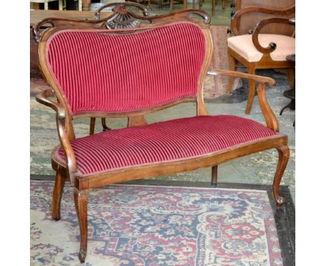 A late Victorian mahogany two seat salon sofa, pierced and shaped cresting top rail, padded back, outswept open arms, serpent