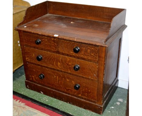 A Victorian scumbled pine wash stand, three quarter gallery, two short drawers over two graduated long, button handles, plint