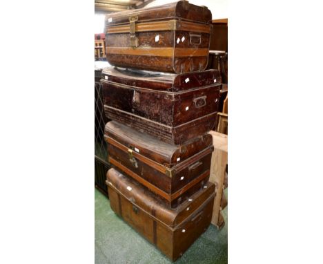 Vintage luggage - four tin trunks of various sizes.