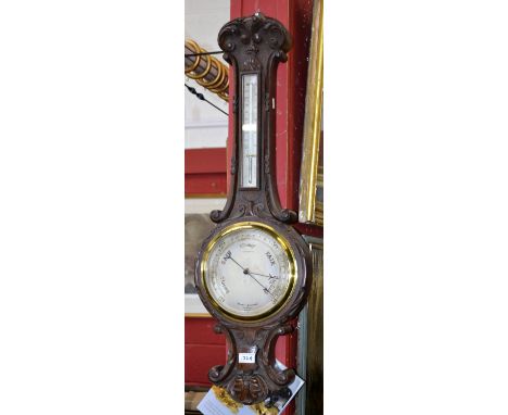 A Victorian oak wheel barometer, the dial inscribed Negretti & Zambra, c.1890