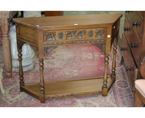 An Old Charm canted console table, single drawer to frieze, turned supports, undertier.