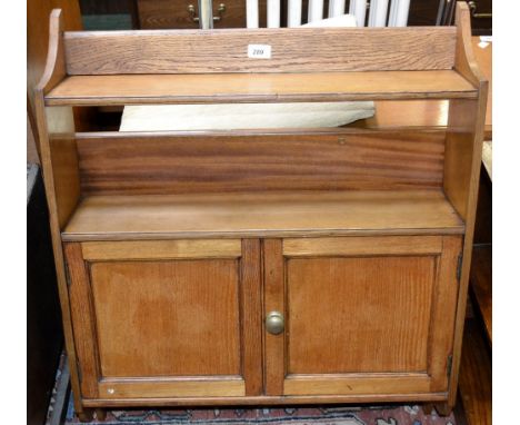  An Edwardian oak and ash wall mounted cupboard/shelf unit.
