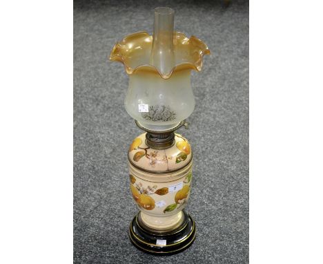 A Victorian oil lamp, the ceramic body painted with flowering and fruiting branches, c.1890, by Williams and Bach, of New Bon