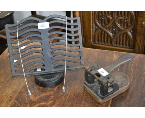 A vintage Brinco hole punch; a cast iron book stand (2)