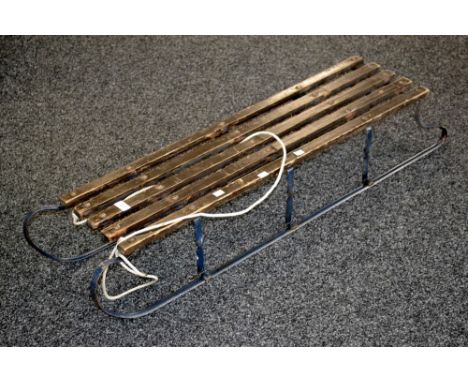 A vintage metal and wooden sledge.