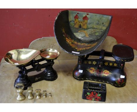 A pair of cast iron balance scales, painted with flowers on a black ground, with weight; a pair of Ibrasco balance scales wit