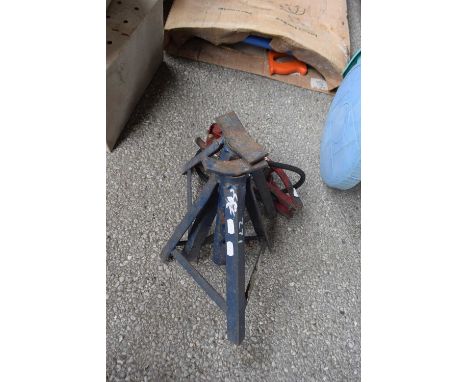 Two axle stands together with a vintage foot pump