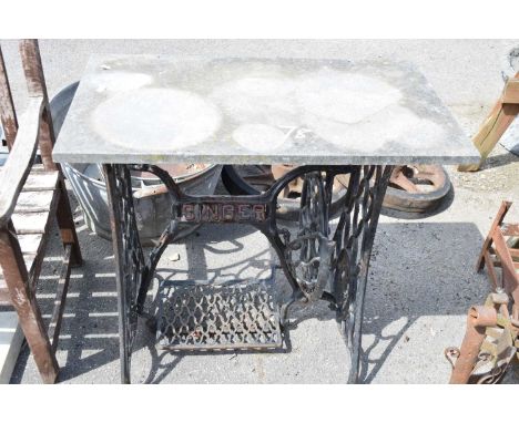 Vintage Singer sewing machine base with a stone top