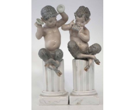 Pair of Lladro Fauns, modelled playing pipes and cymbals whilst sat on a pedestal, incised marks to bases, 27cm high     Cond