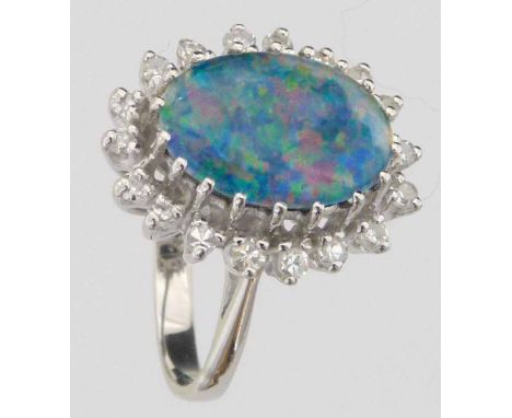 Oval opal doublet within a band of diamonds, set in 18ct white gold, ring size M+, gross weight 4.9g.