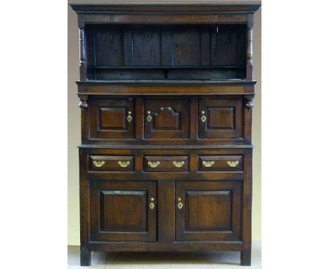 Oak tridarn mid 18th century, the canopy on a recessed central section of raised and fielded panel doors over a base of three