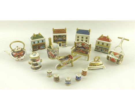 A collection of Royal Crown Derby bone china miniature figurines, comprising four houses, The China Shop, The Toy Box, Georgi