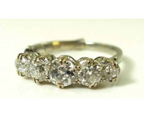 A diamond and platinum five stone ring, the graduated stones approximately 1ct total weight, size J with sprung resizer, size