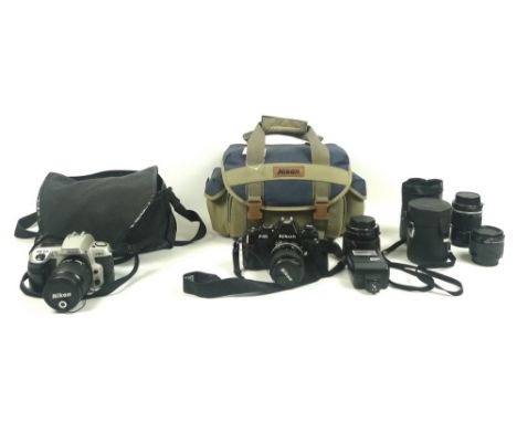 A collection of cameras and lenses including a Nikon F-301 with Jessop 52mm lens on a Nikkor 35-70mm 1:3.3-4.5 lens, a Nikkor