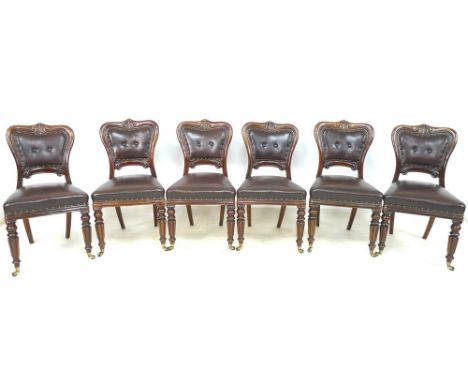 A set of six Victorian mahogany dining chairs, with carved and moulded rails, button backs and seats upholstered in dark brow