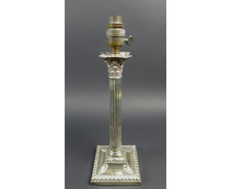 An Edward VII silver candlestick, Corinthian column form on a squared base with gadrooned decoration, later converted to elec