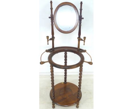 An early 20th century wash stand, with turned supports, oval mirror and candle sconces, bent wood towel rails to either side 