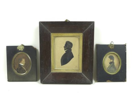 Two 19th portrait miniatures on paper of gentlemen, in oval inset ebonised frames together with a silhouette study of a Victo