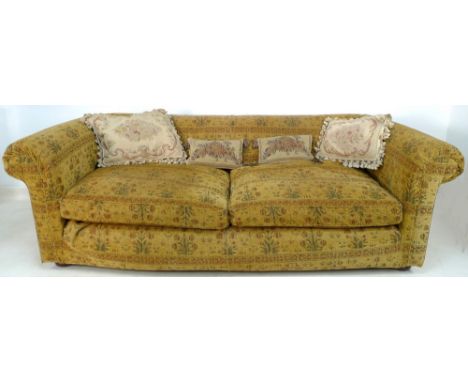 A late 20th century Chesterfield style three seater sofa, upholstered in gold chenille fabric decorated with roses, with two 