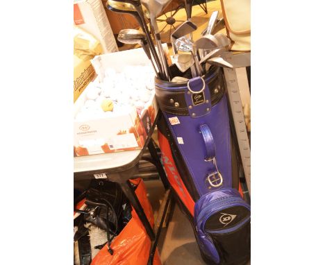 Dunlop golf bag containing clubs and a box of balls. This lot is not available for in-house P&amp;P. 